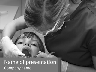 A Young Boy Getting His Teeth Checked By A Dentist PowerPoint Template