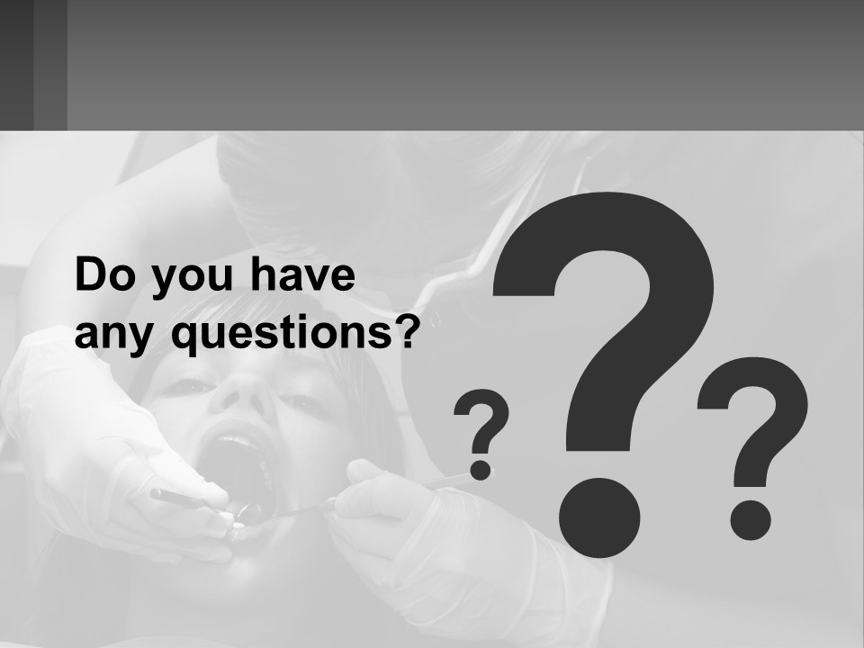 A Young Boy Getting His Teeth Checked By A Dentist PowerPoint Template