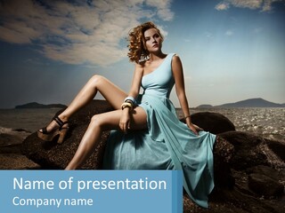 A Woman In A Blue Dress Is Sitting On A Rock PowerPoint Template