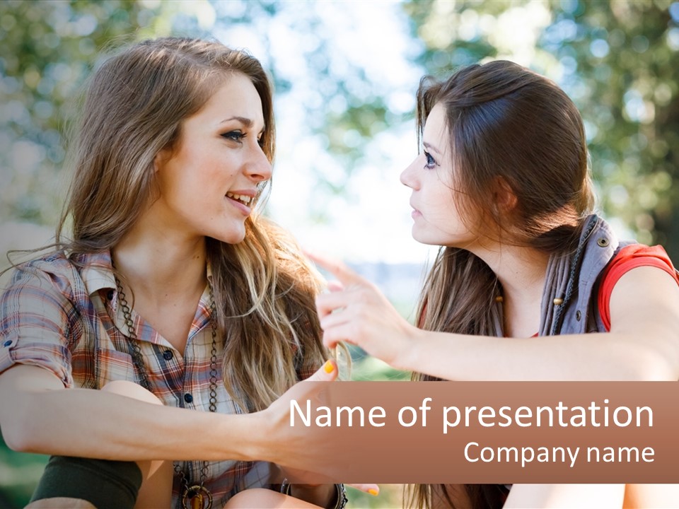 Two Young Women Talking To Each Other In A Park PowerPoint Template