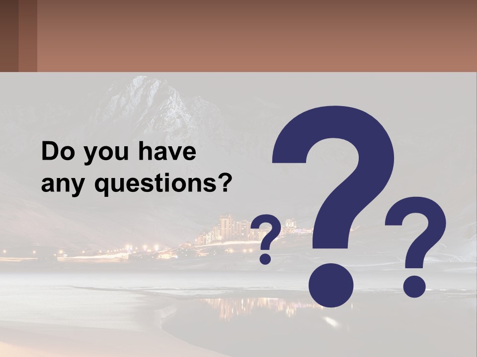 A Snowy Mountain With A Town Lit Up At Night PowerPoint Template