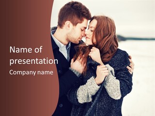 A Man And A Woman Kissing In Front Of A Brown Background PowerPoint Template