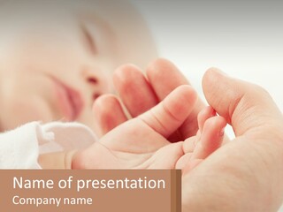 A Person Holding A Baby In Their Hands PowerPoint Template