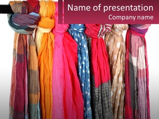 A Bunch Of Scarves Hanging On A Rack PowerPoint Template