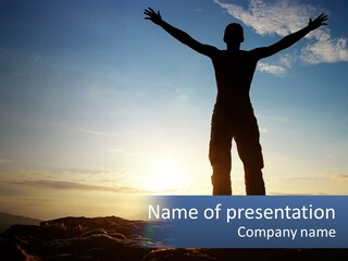 A Man Standing On Top Of A Mountain With His Arms Wide Open PowerPoint Template