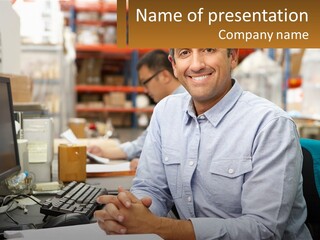 A Man Sitting At A Desk In Front Of A Computer PowerPoint Template