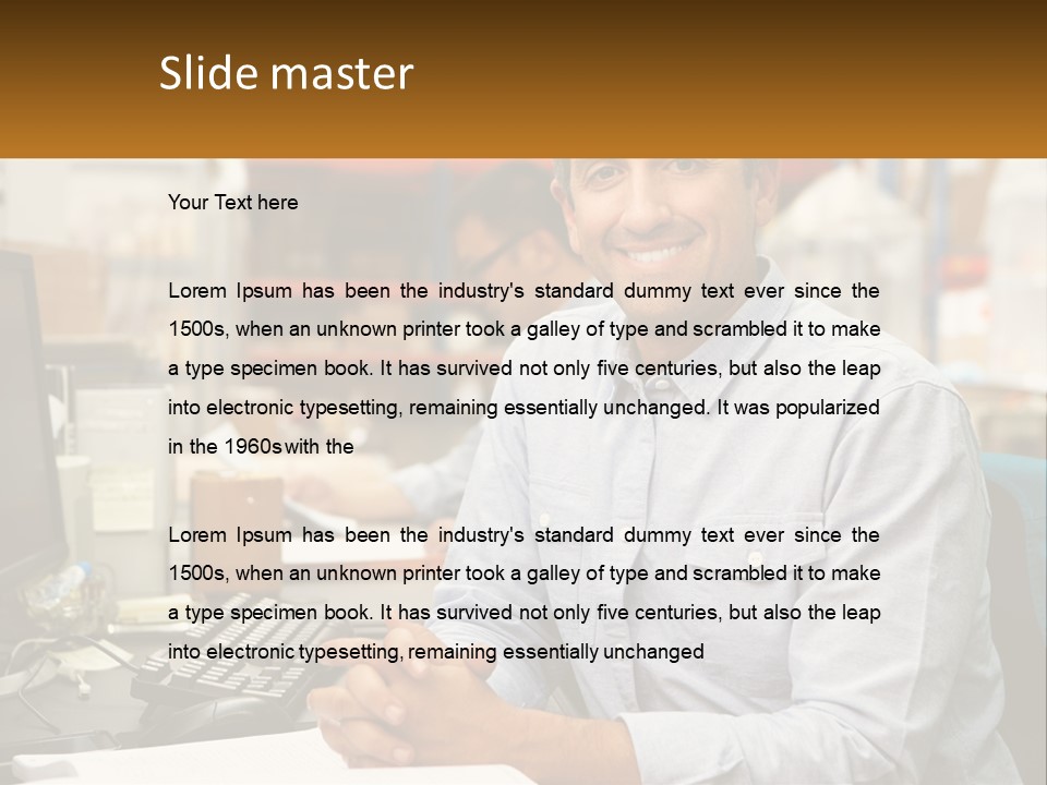 A Man Sitting At A Desk In Front Of A Computer PowerPoint Template