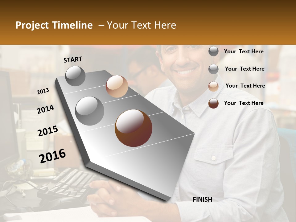 A Man Sitting At A Desk In Front Of A Computer PowerPoint Template