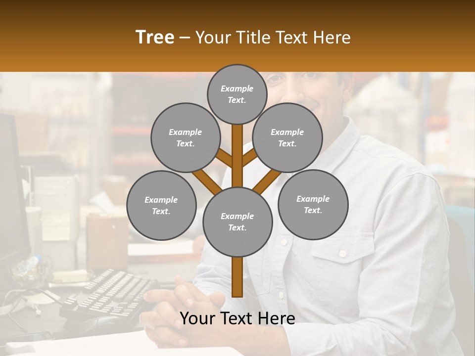 A Man Sitting At A Desk In Front Of A Computer PowerPoint Template