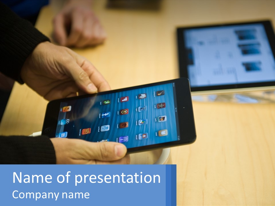 A Person Holding A Tablet On A Table PowerPoint Template