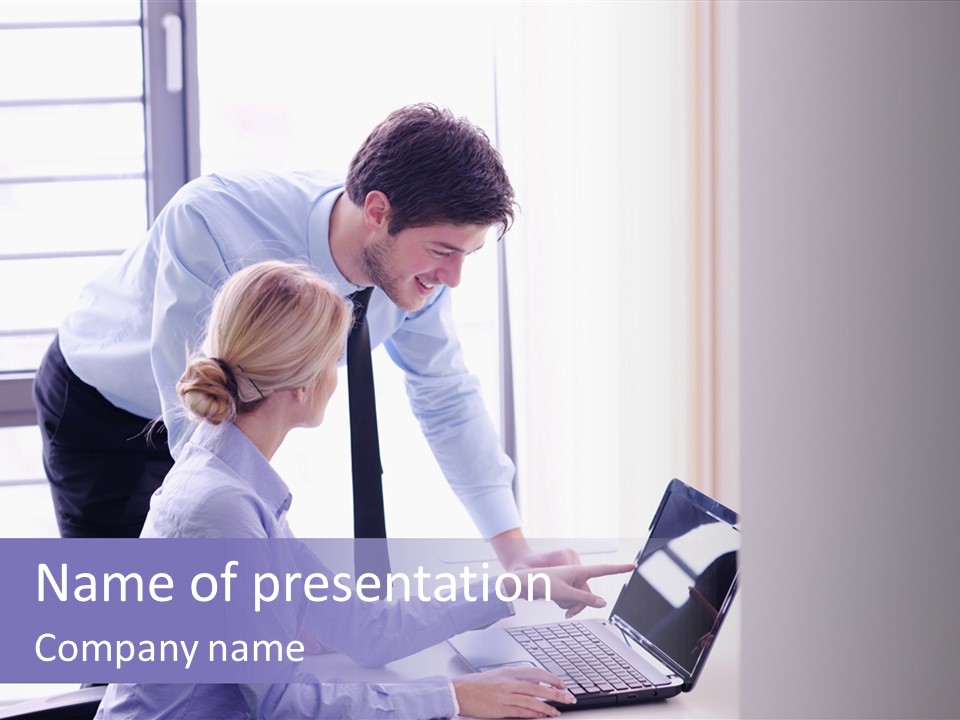 A Man And A Woman Looking At A Laptop PowerPoint Template