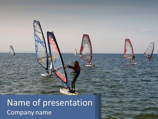 A Woman Windsurfing In The Ocean With Other Sailboats In The Background PowerPoint Template