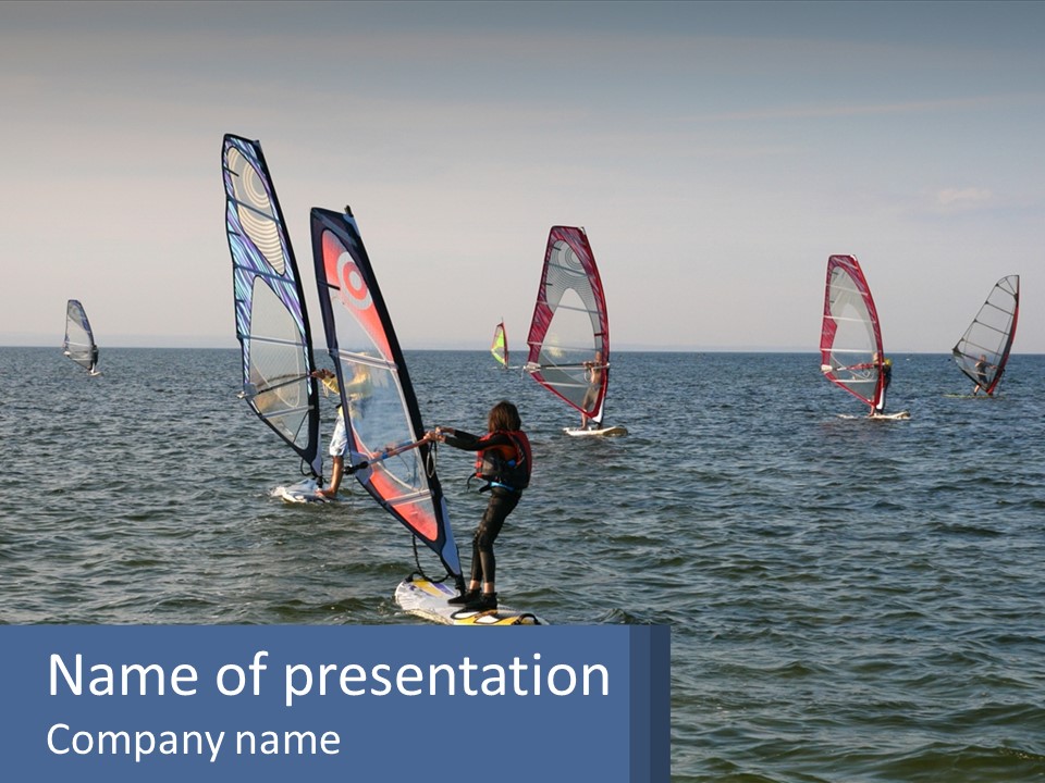 A Woman Windsurfing In The Ocean With Other Sailboats In The Background PowerPoint Template