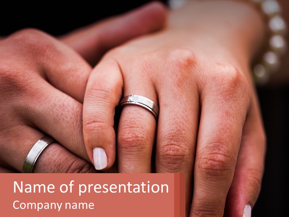 Two People Holding Hands With Wedding Rings On Their Fingers PowerPoint Template