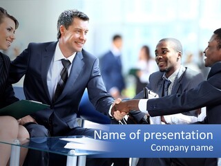 A Group Of Business People Shaking Hands Over A Table PowerPoint Template