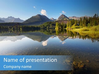A Lake With Mountains In The Background And A Blue Sky PowerPoint Template