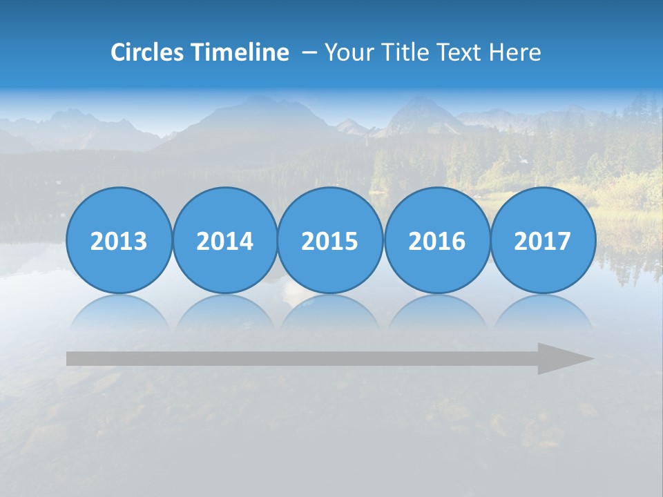 A Lake With Mountains In The Background And A Blue Sky PowerPoint Template
