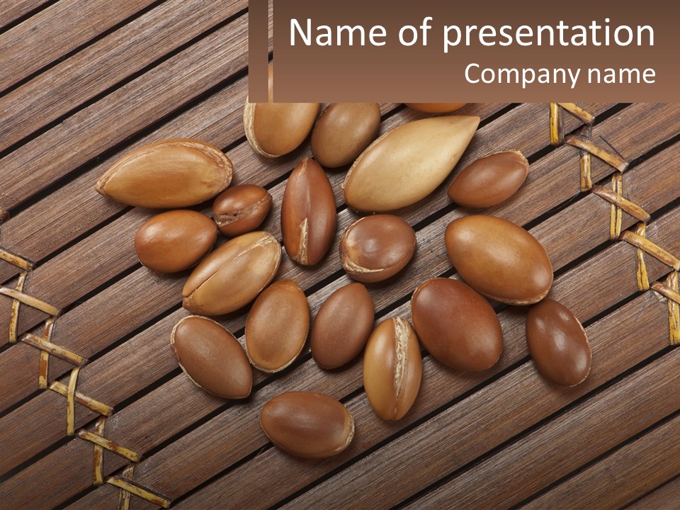 A Bunch Of Nuts On A Wooden Table PowerPoint Template