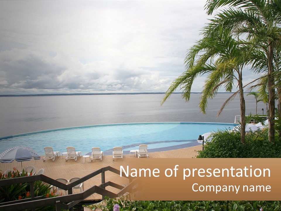 A Large Swimming Pool Next To The Ocean PowerPoint Template
