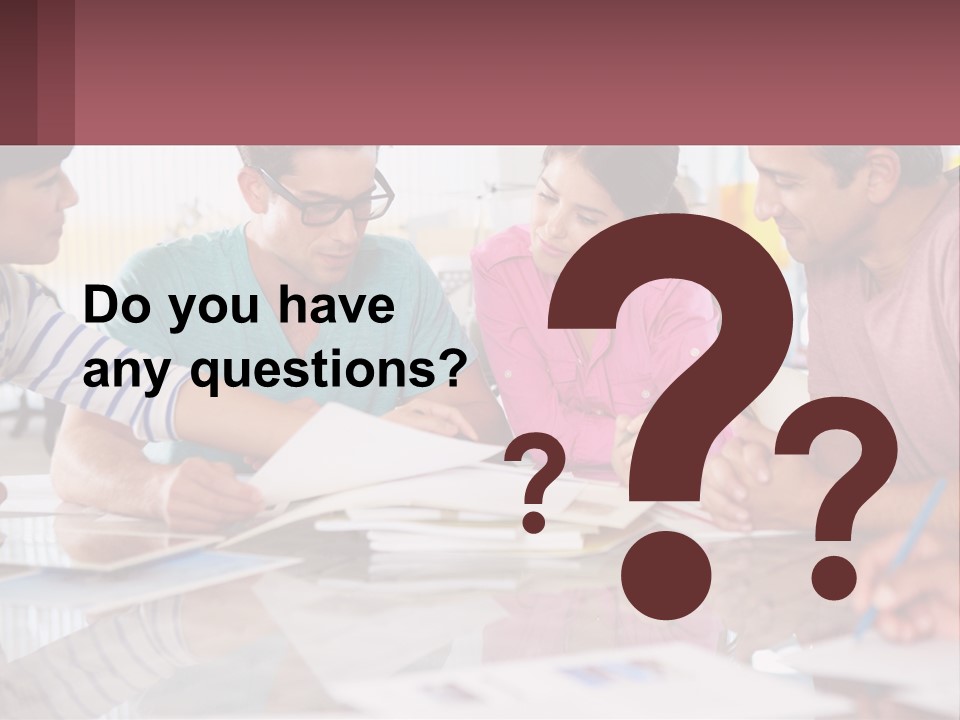 A Group Of People Sitting Around A Table Writing PowerPoint Template