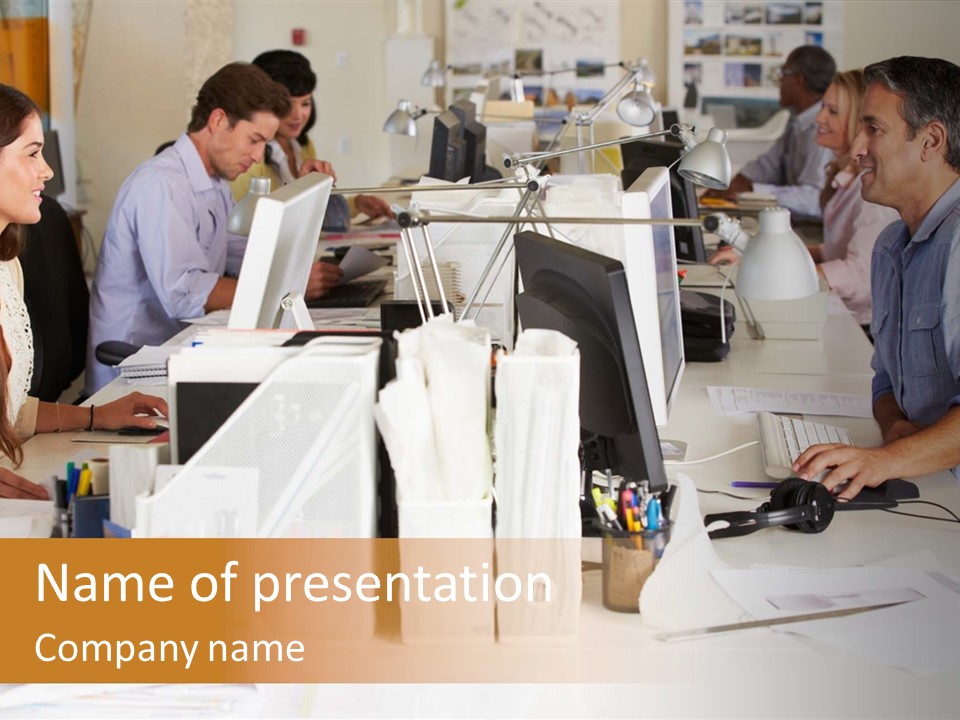 A Group Of People Working On Computers In An Office PowerPoint Template
