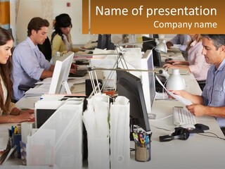 A Group Of People Working On Computers In An Office PowerPoint Template