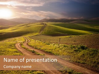 A Dirt Road In The Middle Of A Green Field PowerPoint Template