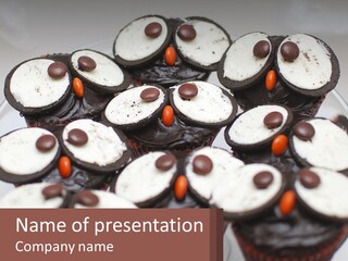 A Plate Of Chocolate Cupcakes With White And Brown Frosting PowerPoint Template