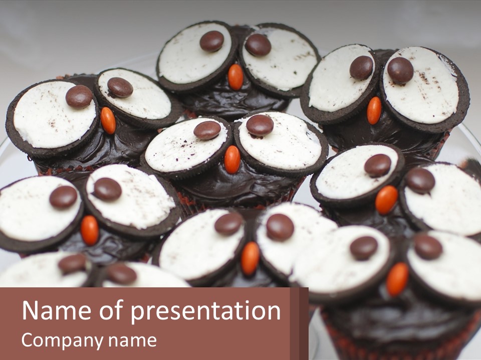 A Plate Of Chocolate Cupcakes With White And Brown Frosting PowerPoint Template