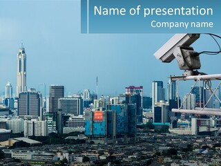 A Security Camera On Top Of A Building In A City PowerPoint Template