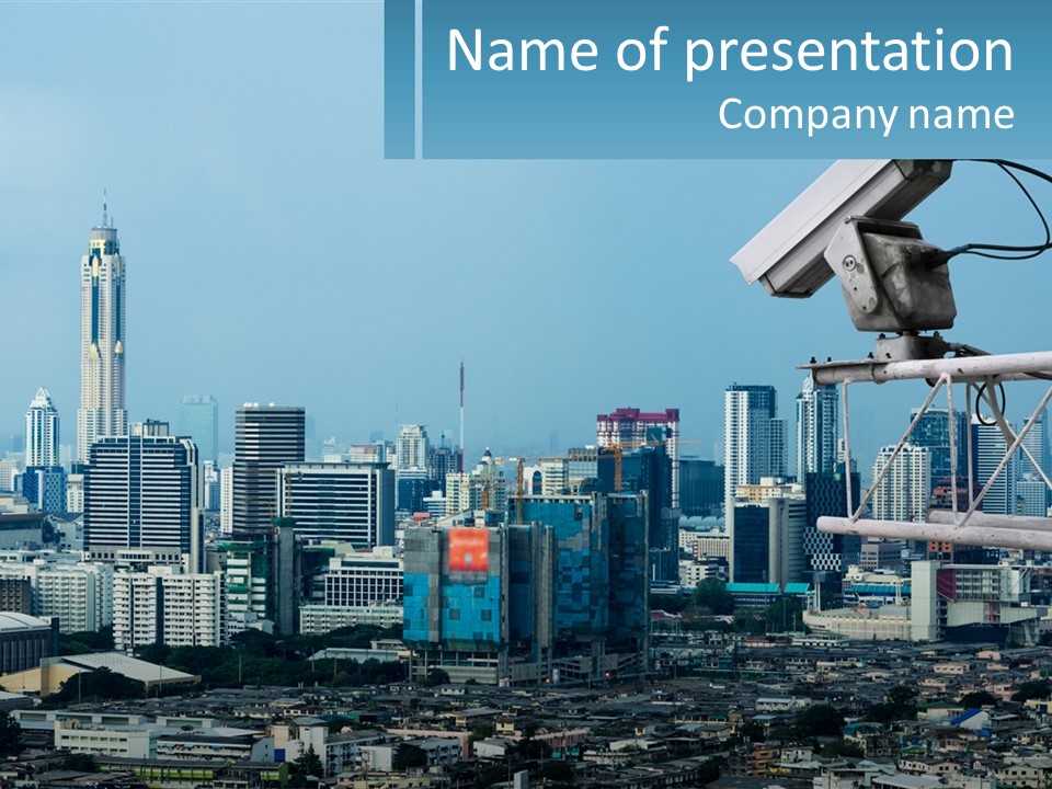 A Security Camera On Top Of A Building In A City PowerPoint Template