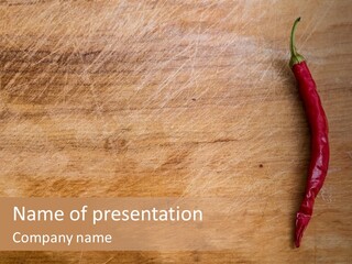 A Red Chili Pepper Sitting On Top Of A Wooden Table PowerPoint Template