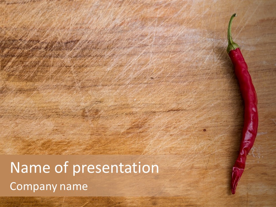 A Red Chili Pepper Sitting On Top Of A Wooden Table PowerPoint Template