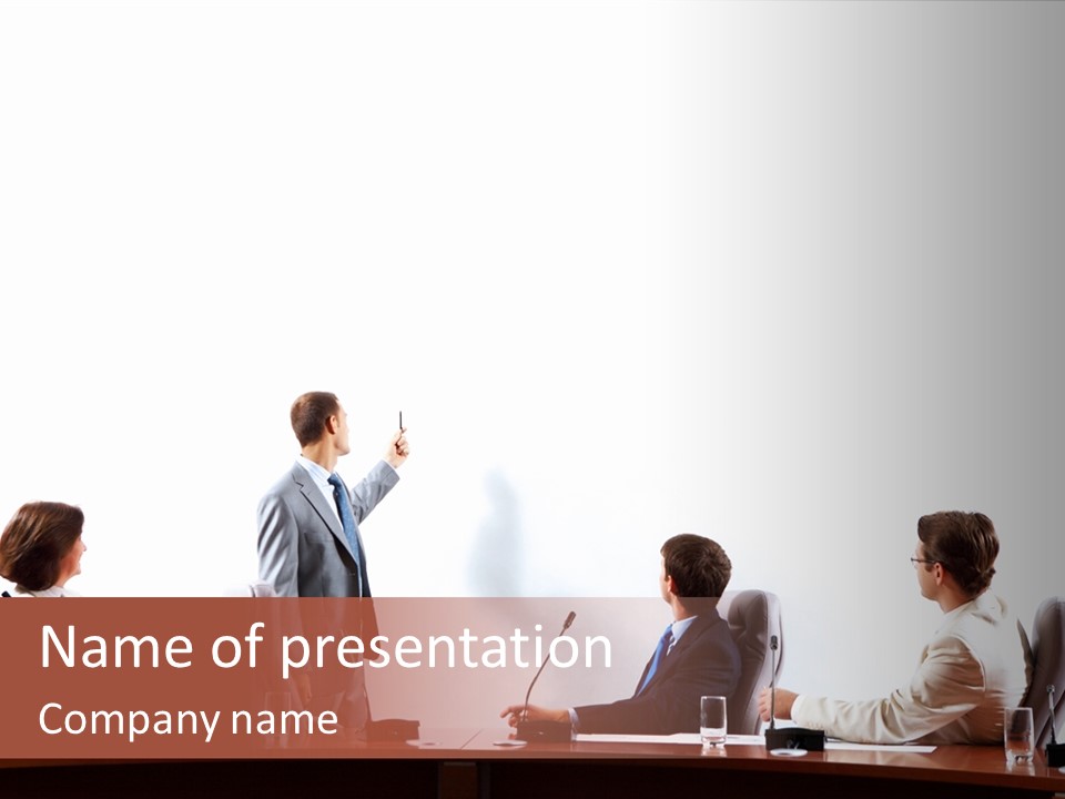 A Group Of People Sitting Around A Conference Table PowerPoint Template