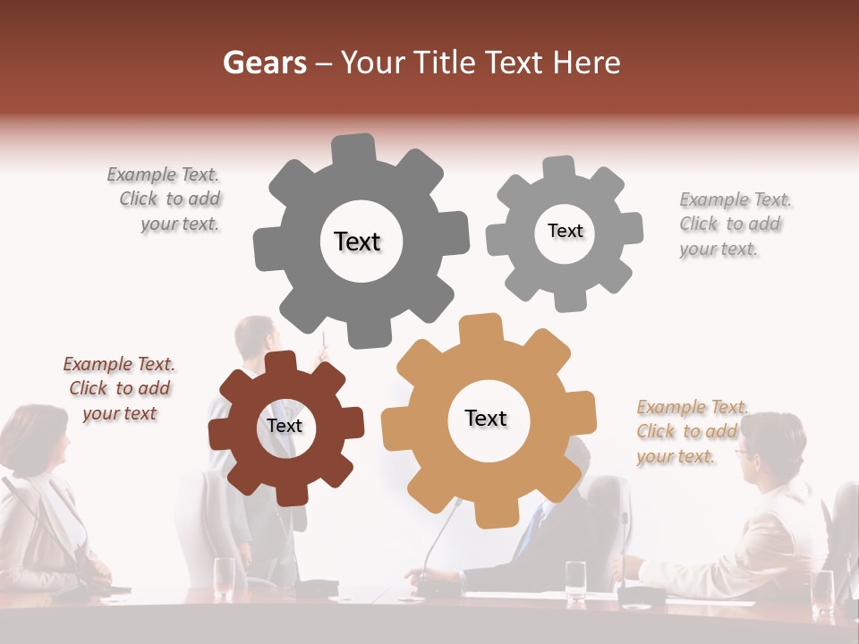A Group Of People Sitting Around A Conference Table PowerPoint Template