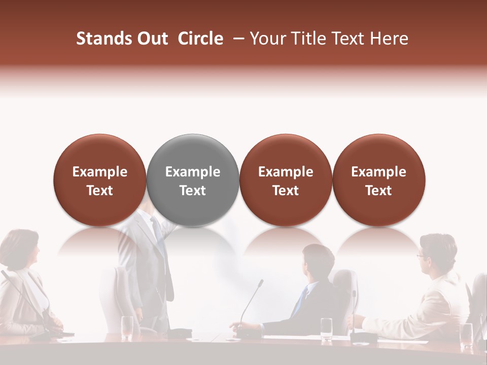 A Group Of People Sitting Around A Conference Table PowerPoint Template