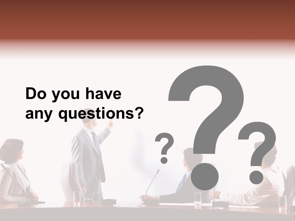 A Group Of People Sitting Around A Conference Table PowerPoint Template