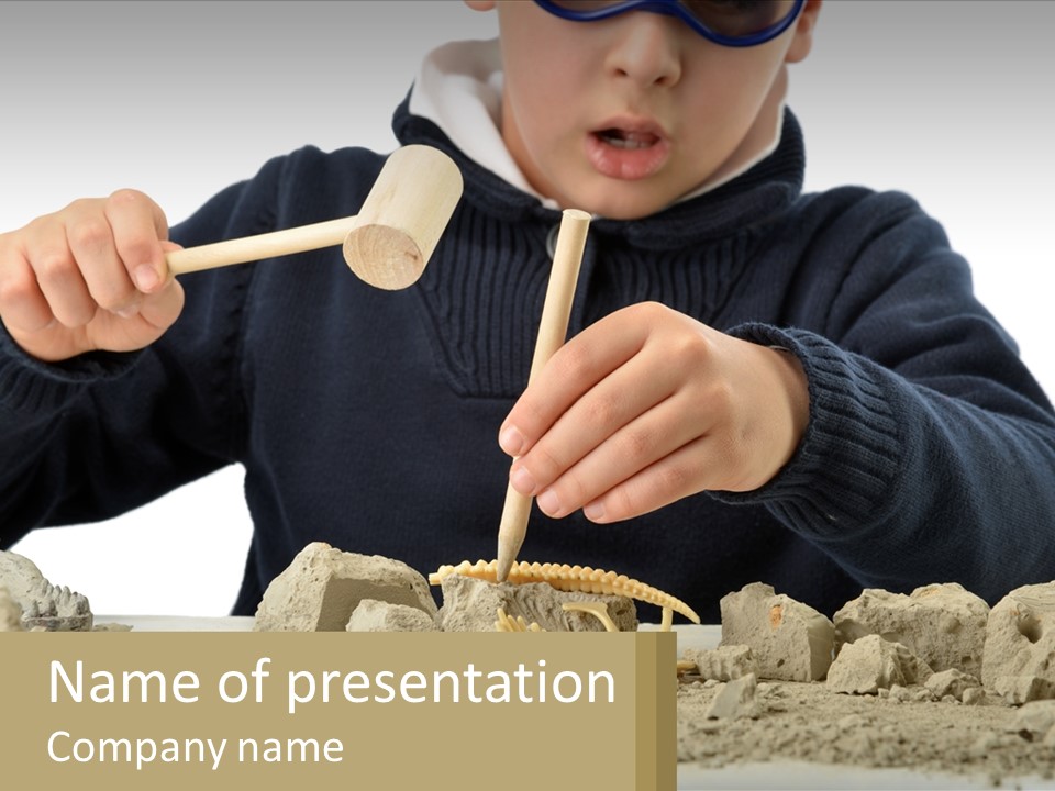A Young Boy Is Playing With A Wooden Spoon PowerPoint Template
