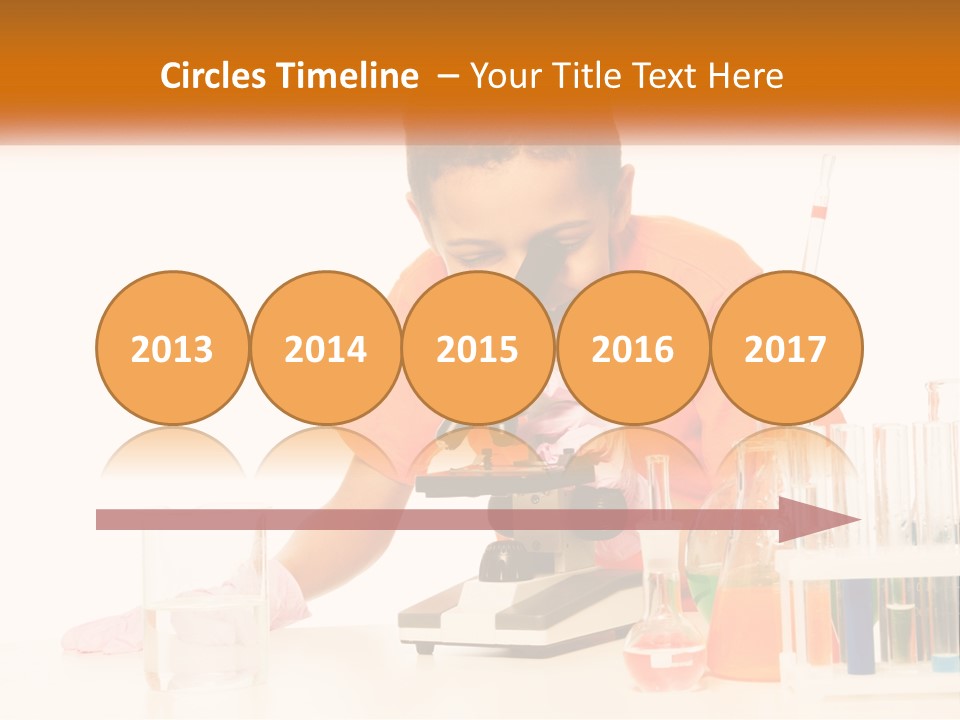 A Young Boy Is Looking Through A Microscope PowerPoint Template