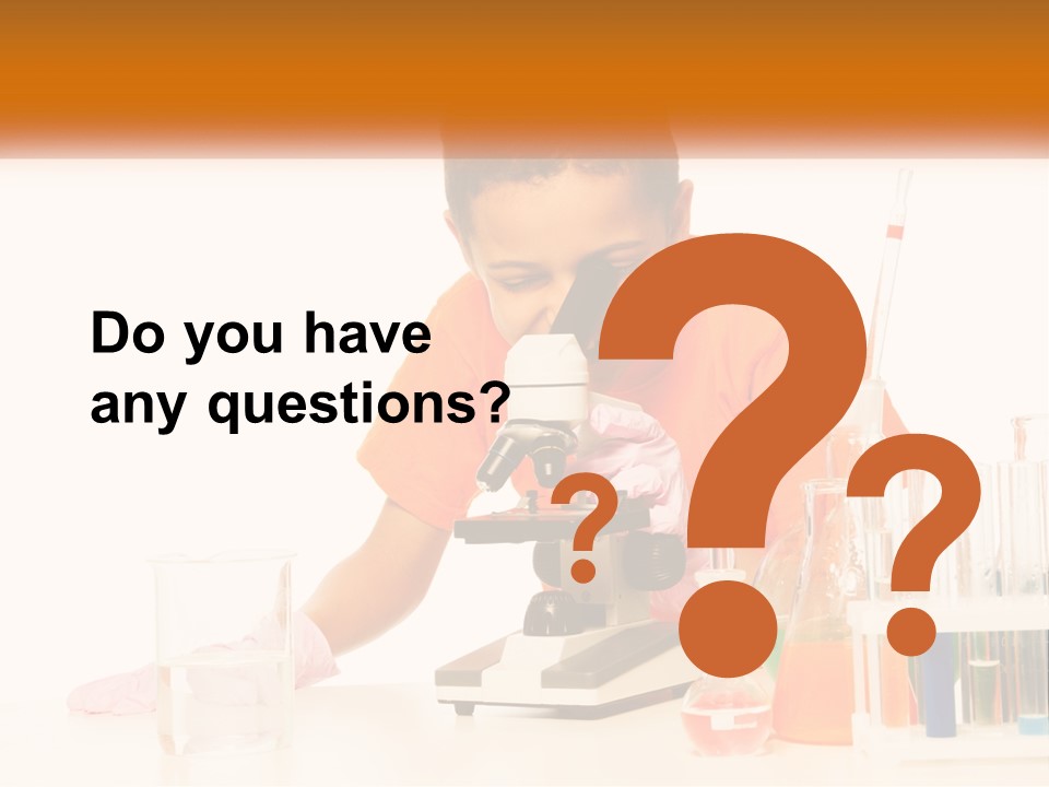 A Young Boy Is Looking Through A Microscope PowerPoint Template