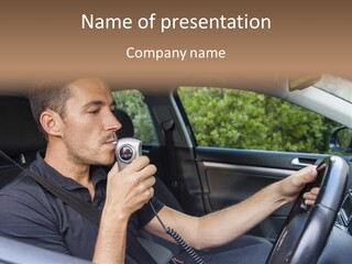 A Man Sitting In A Car Holding A Camera PowerPoint Template