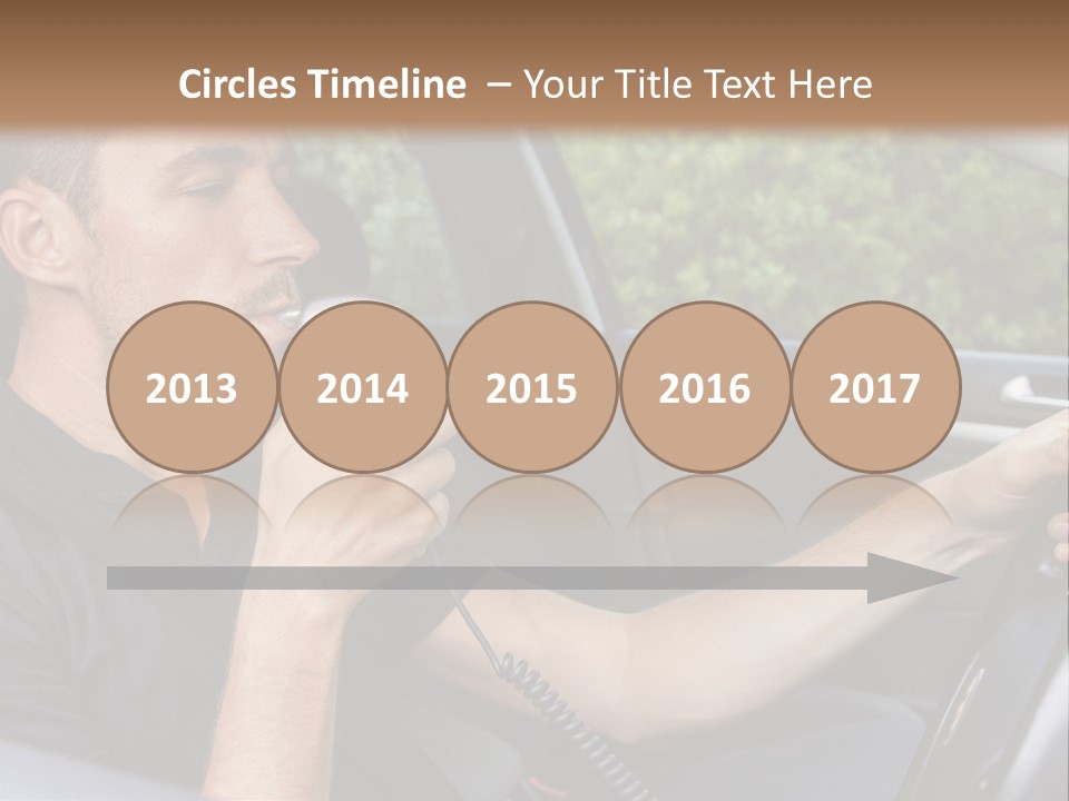 A Man Sitting In A Car Holding A Camera PowerPoint Template