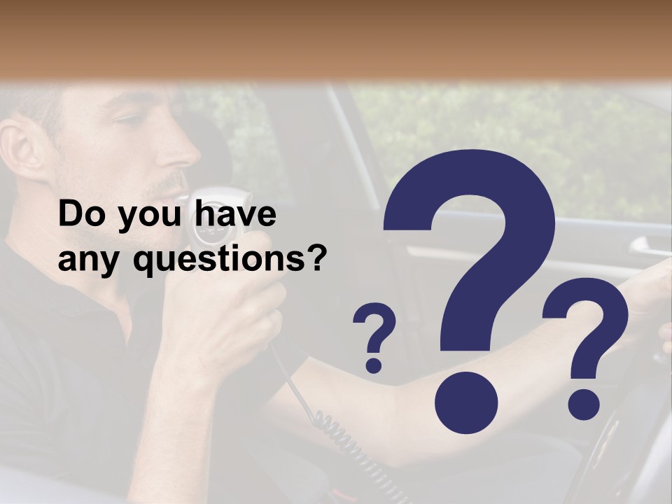 A Man Sitting In A Car Holding A Camera PowerPoint Template