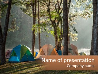 A Group Of Tents In The Woods With A Lake In The Background PowerPoint Template