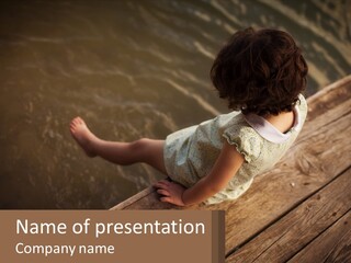 A Little Girl Sitting On A Dock Looking At The Water PowerPoint Template