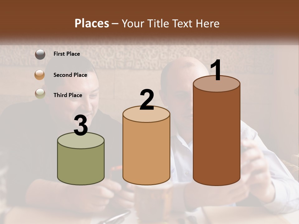 Two Men Sitting At A Table Looking At A Cell Phone PowerPoint Template
