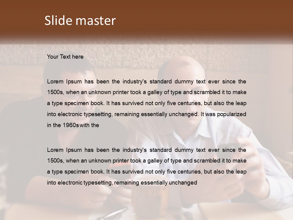 Two Men Sitting At A Table Looking At A Cell Phone PowerPoint Template