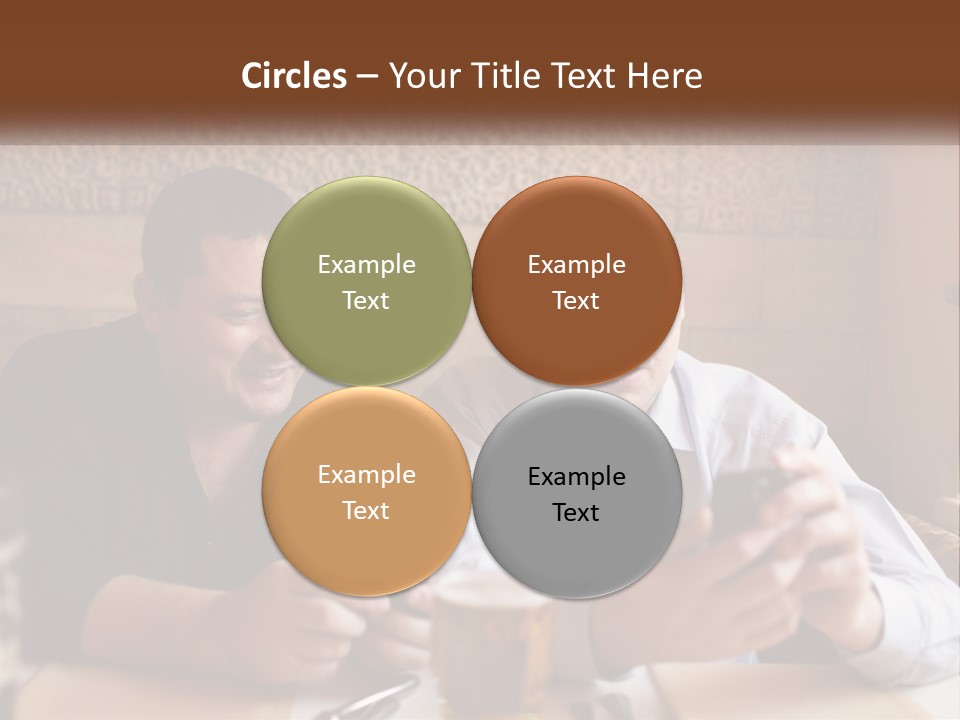Two Men Sitting At A Table Looking At A Cell Phone PowerPoint Template
