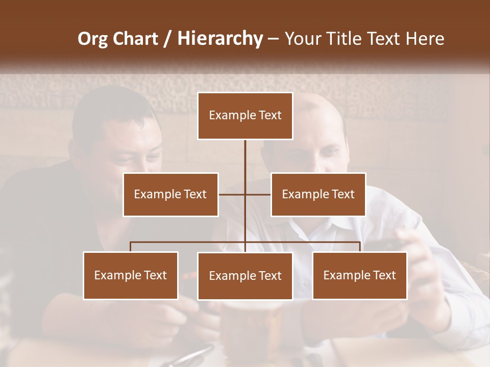 Two Men Sitting At A Table Looking At A Cell Phone PowerPoint Template