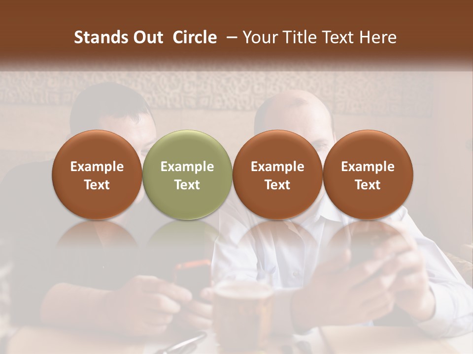 Two Men Sitting At A Table Looking At A Cell Phone PowerPoint Template